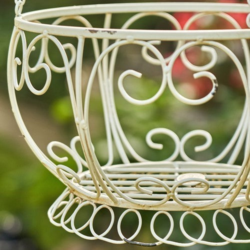 Close-up of curled wire scrollwork and looped trim on the cream basket