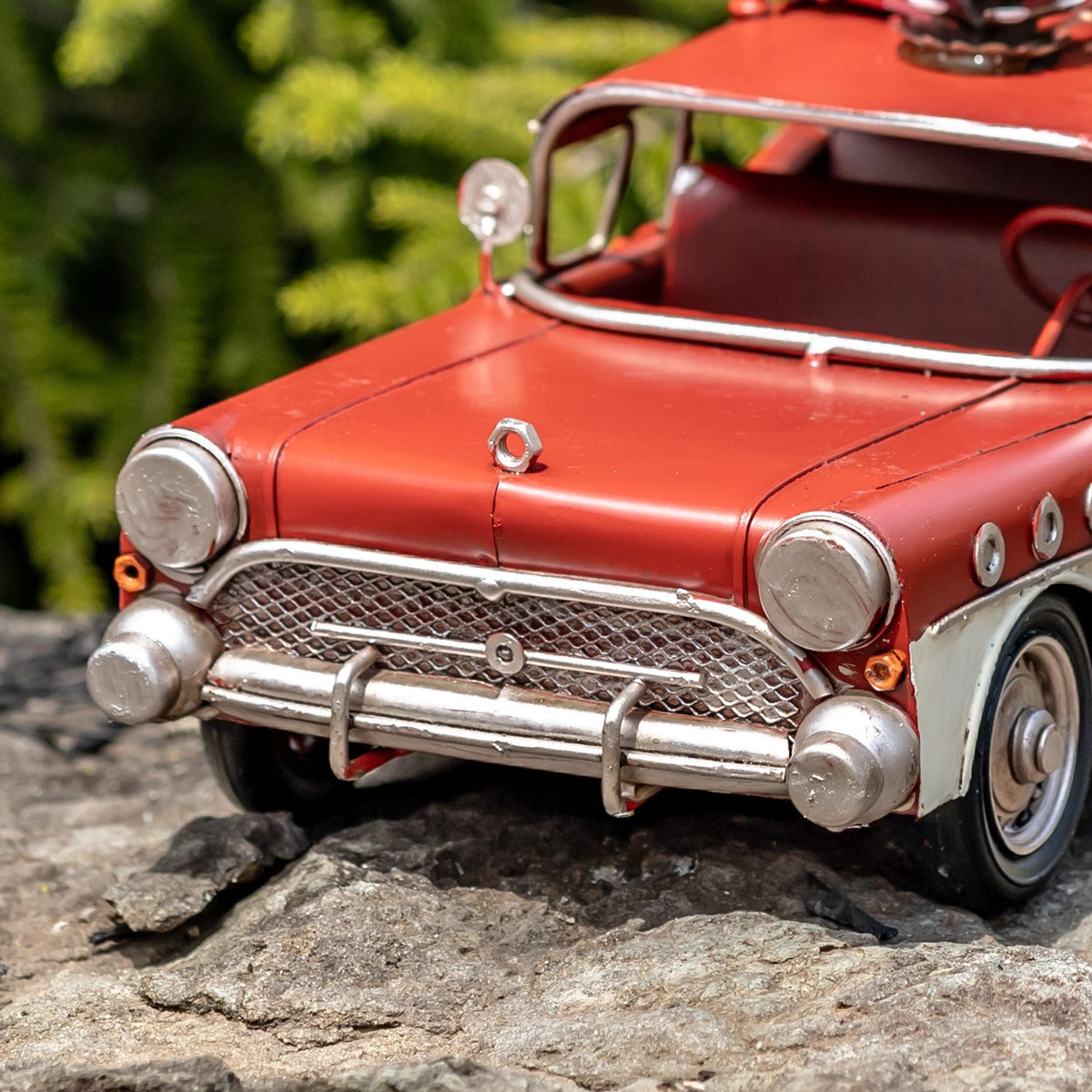 Close angled view of the wagon's red hood, headlights and front grille