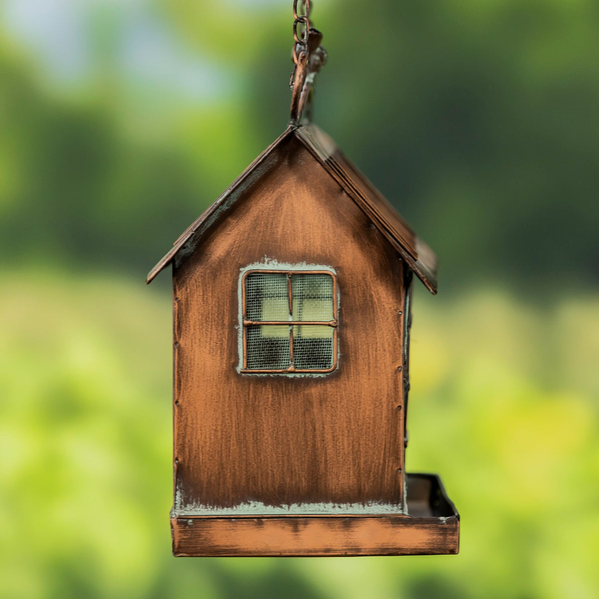 Side of the hanging feeder showing its gabled roof, single mesh window, and shallow base tray.