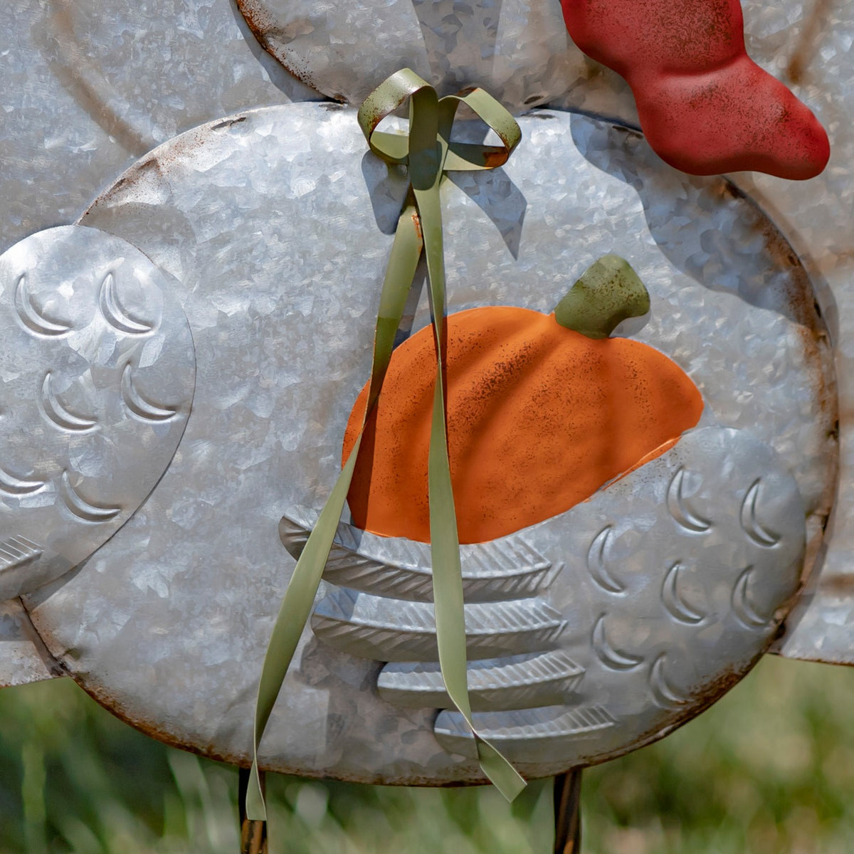 Galvanized turkey body with an orange pumpkin accent, embossed feather details, and a green ribbon.