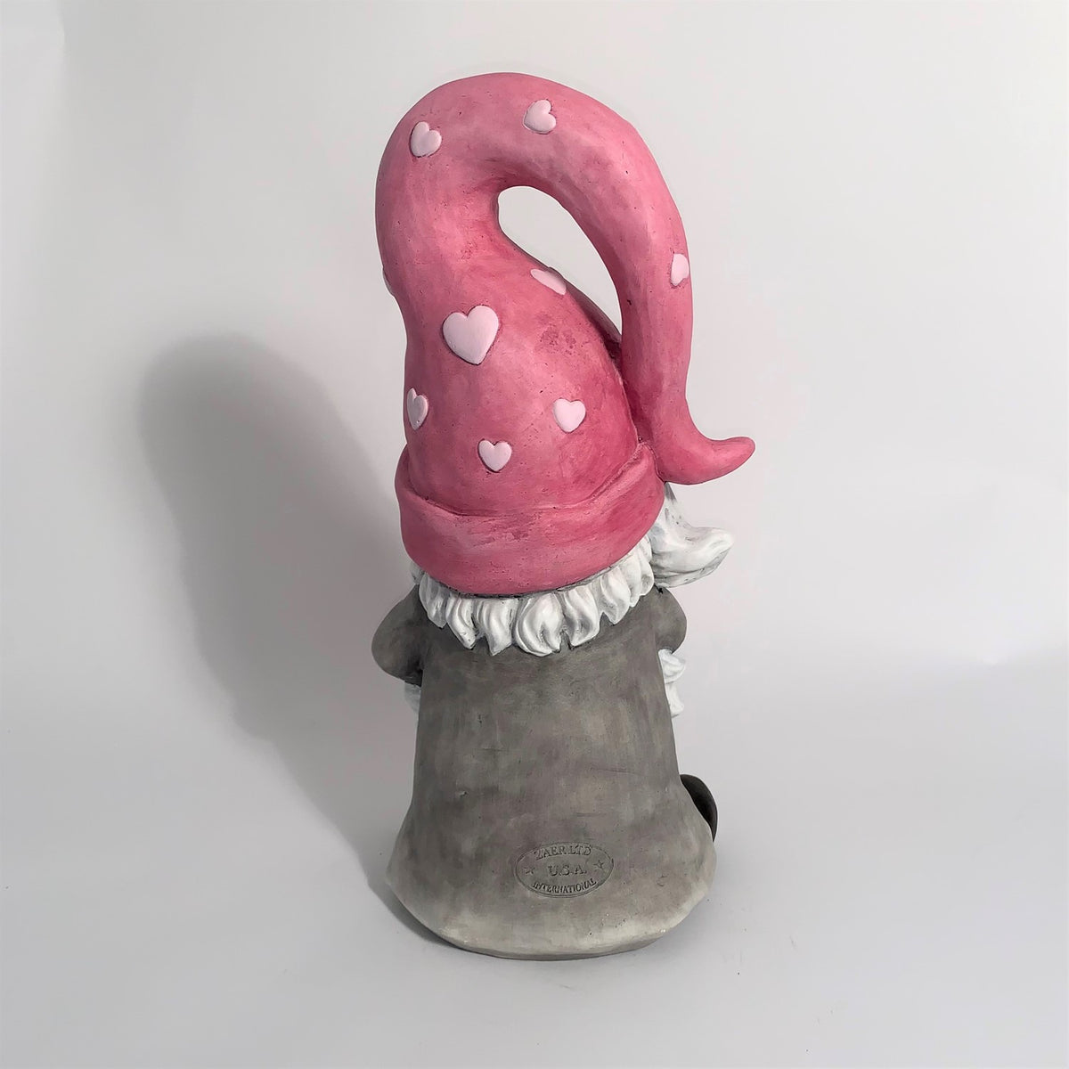 Rear view showing the gnome's pink heart-patterned hat and grey robe