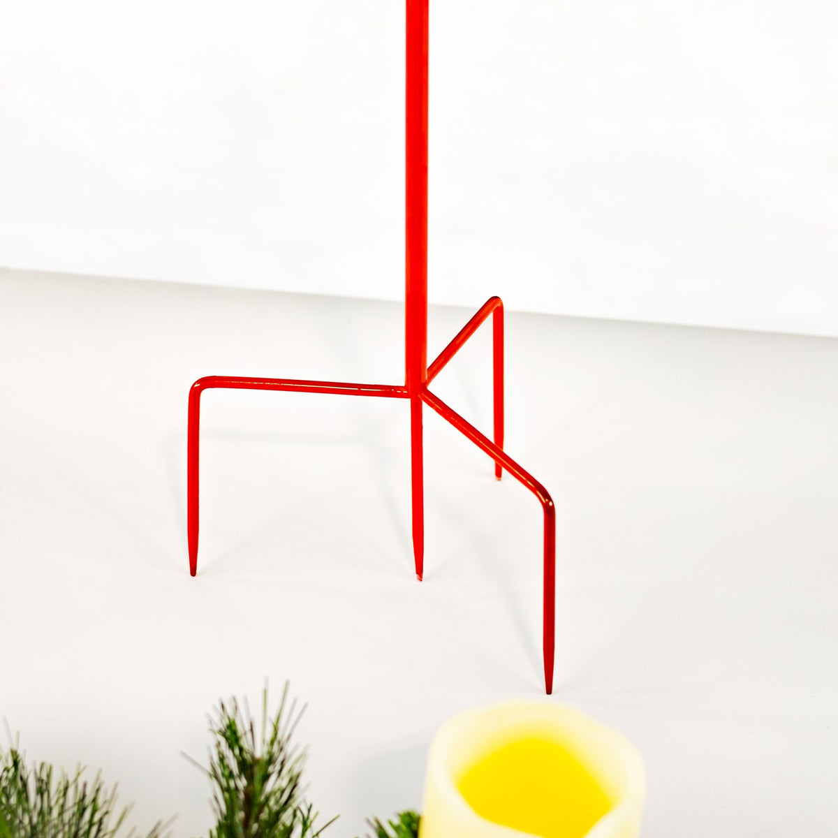 Red metal stake stem with bent support legs shown against a plain white background.