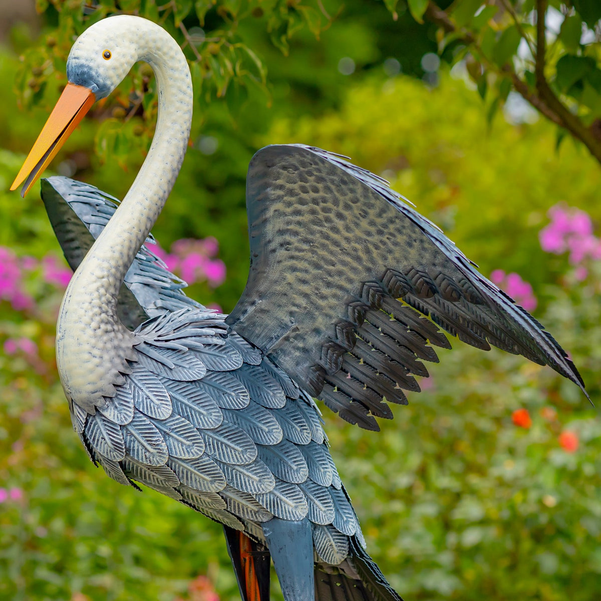 Close angled view of a heron's blue-grey feathered body and spread wing
