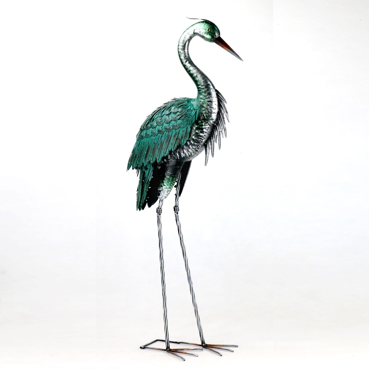 Metal heron figurine standing with folded wings and its beak angled downward.