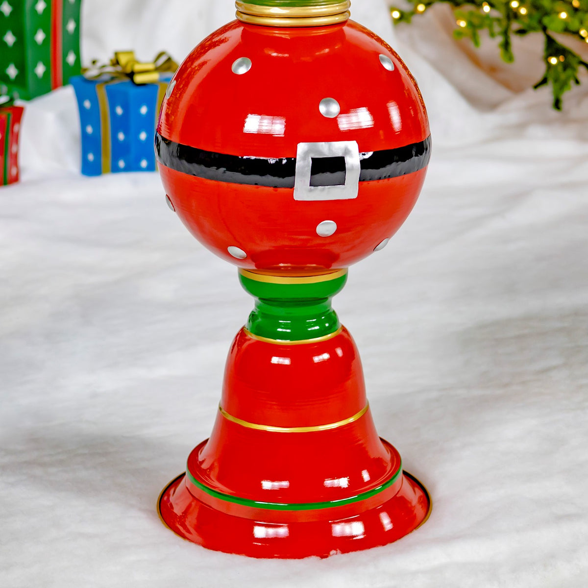 Close view of the tower’s red ornament, black belt band, silver buckle, and green-and-gold base accents.