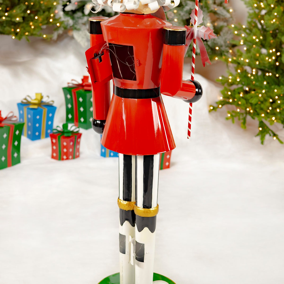 Rear view of the nutcracker’s red jacket, black-and-white legs, and striped candy cane.