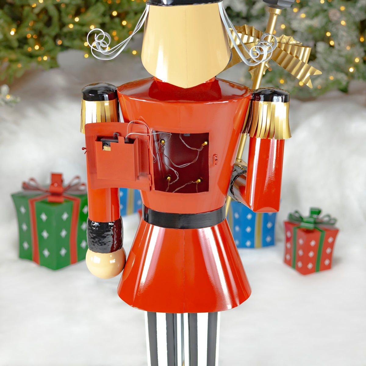 Back of the nutcracker showing an open panel and visible wiring on its red coat.
