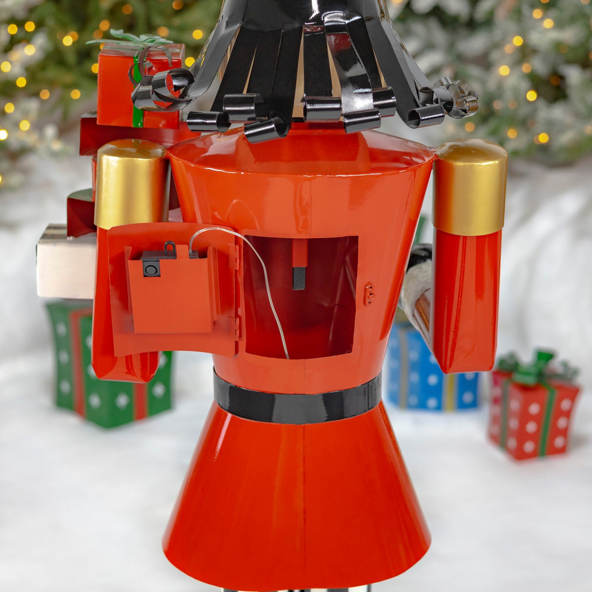 The nutcracker’s red back has an open access panel, with a wire visible inside.