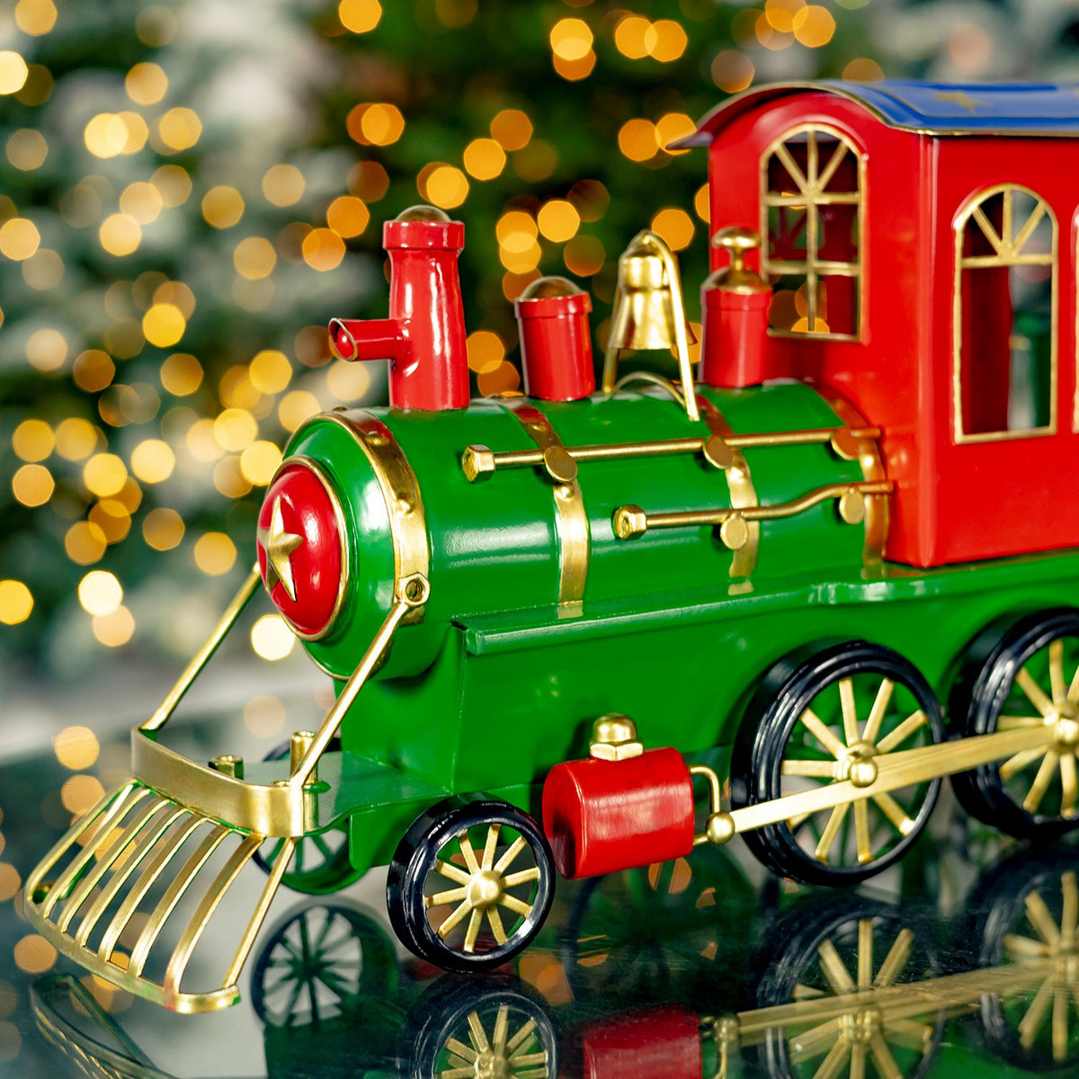 Close-up of the green locomotive, red headlamp, and gold-tone details