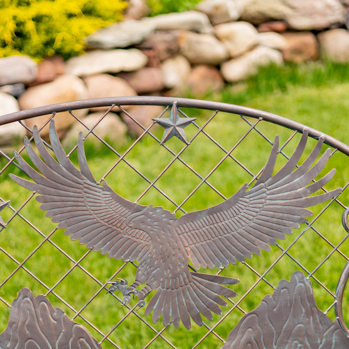 An iron eagle with outstretched wings sits against a diamond lattice, with a star above it.