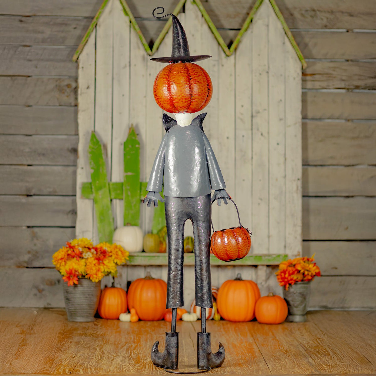 Full-length rear view of the jack-o'-lantern figure holding its orange basket