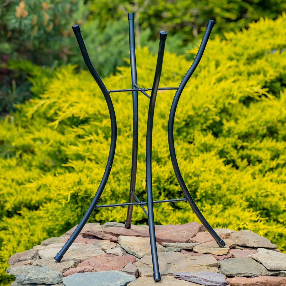 Freestanding black iron birdbath stand shown without its glass bowl