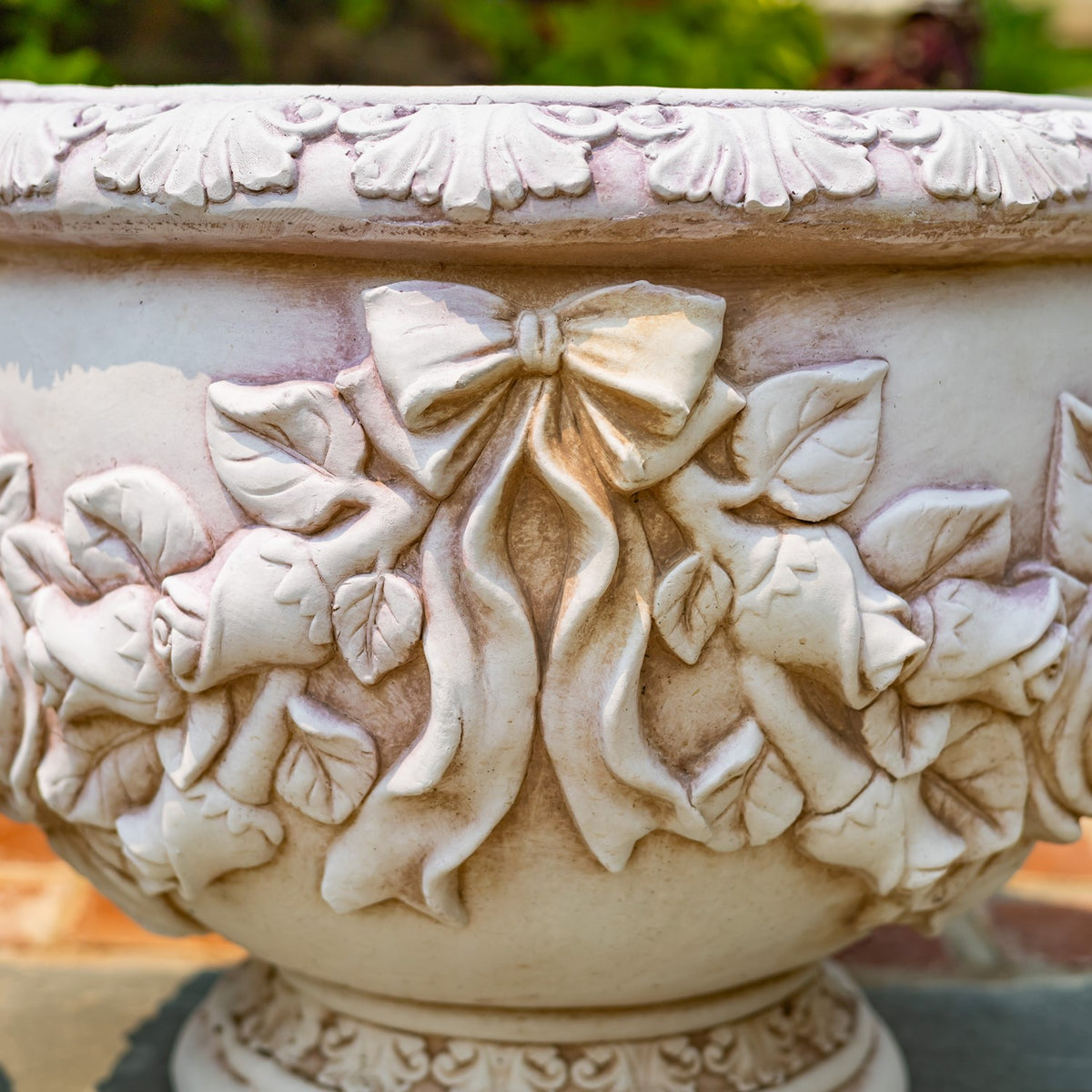 Close-up of the pot’s raised bow, leaves, flowers, and patterned rim.