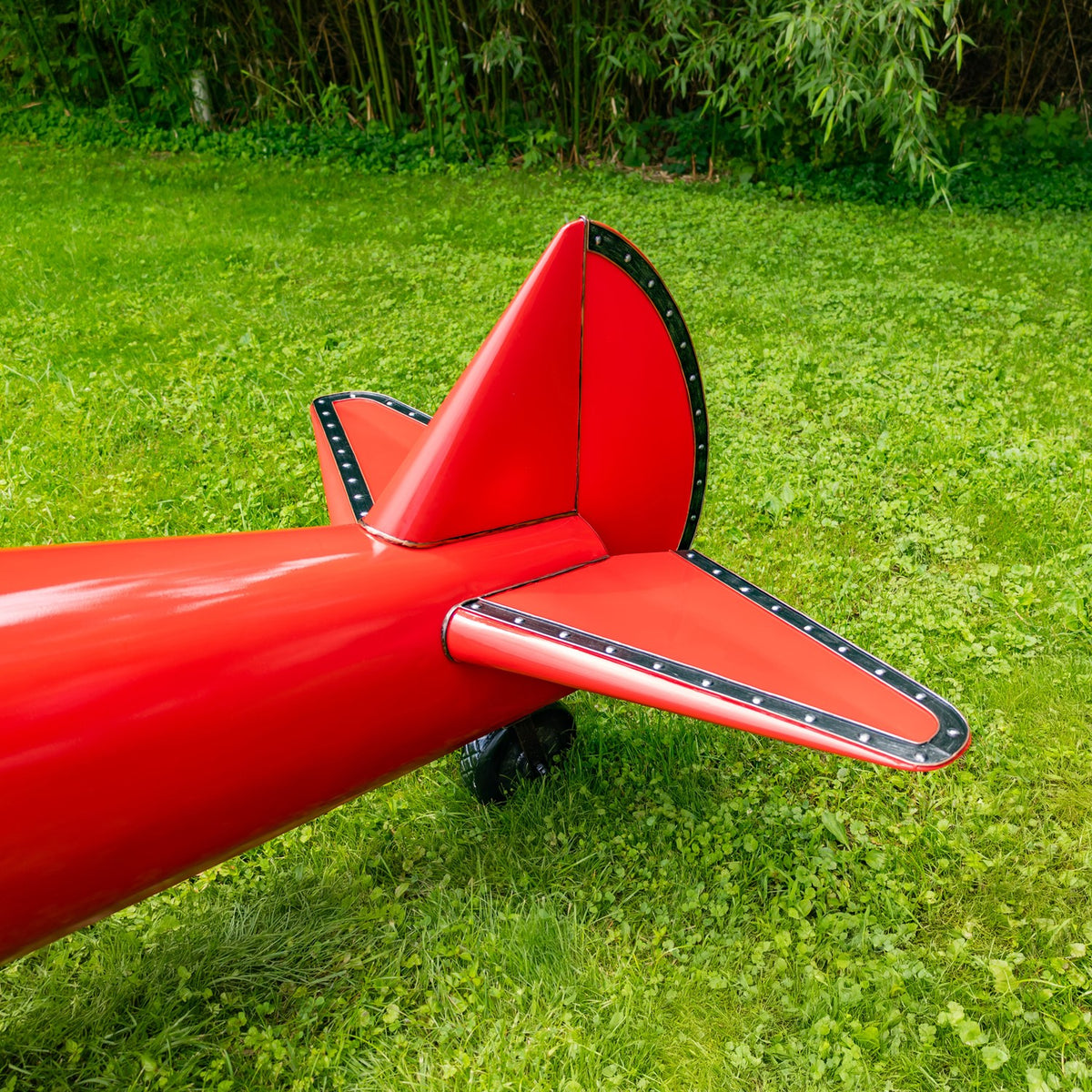 Close-up of the red biplane's tail and horizontal stabilizer
