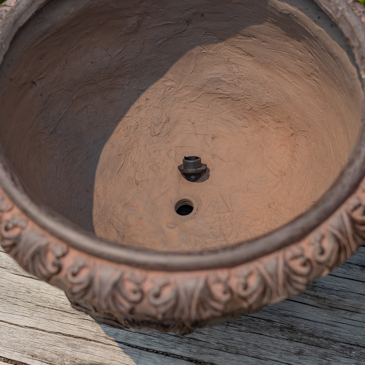 Top-down view inside the planter, showing its textured interior and drainage hole.
