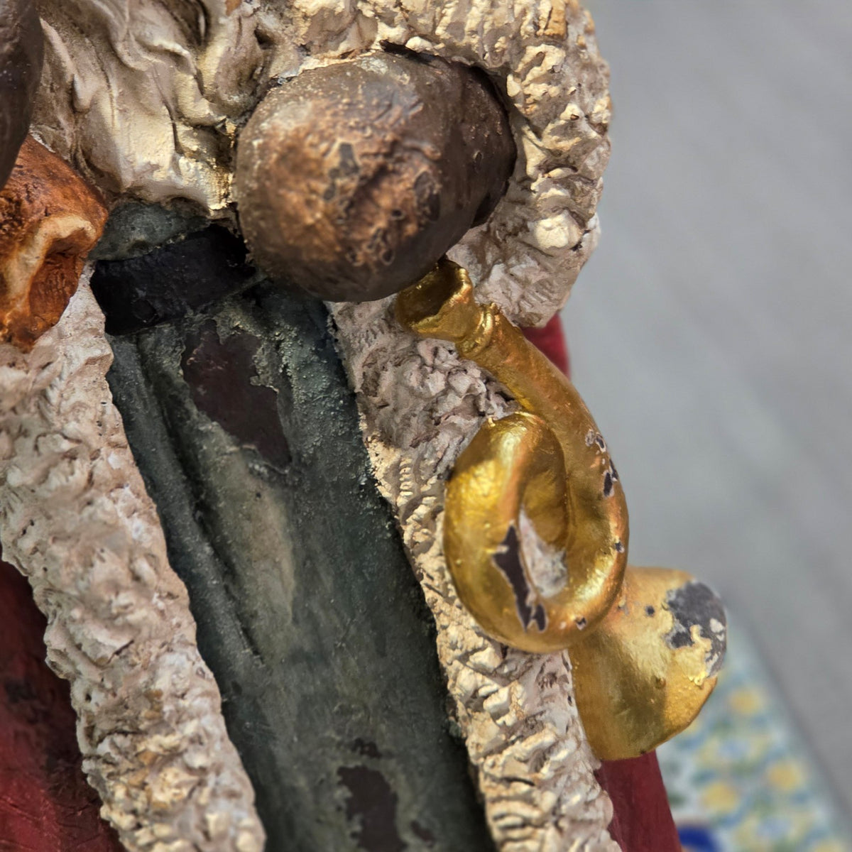 Detail view of the gold horn and Santa's hands and coat