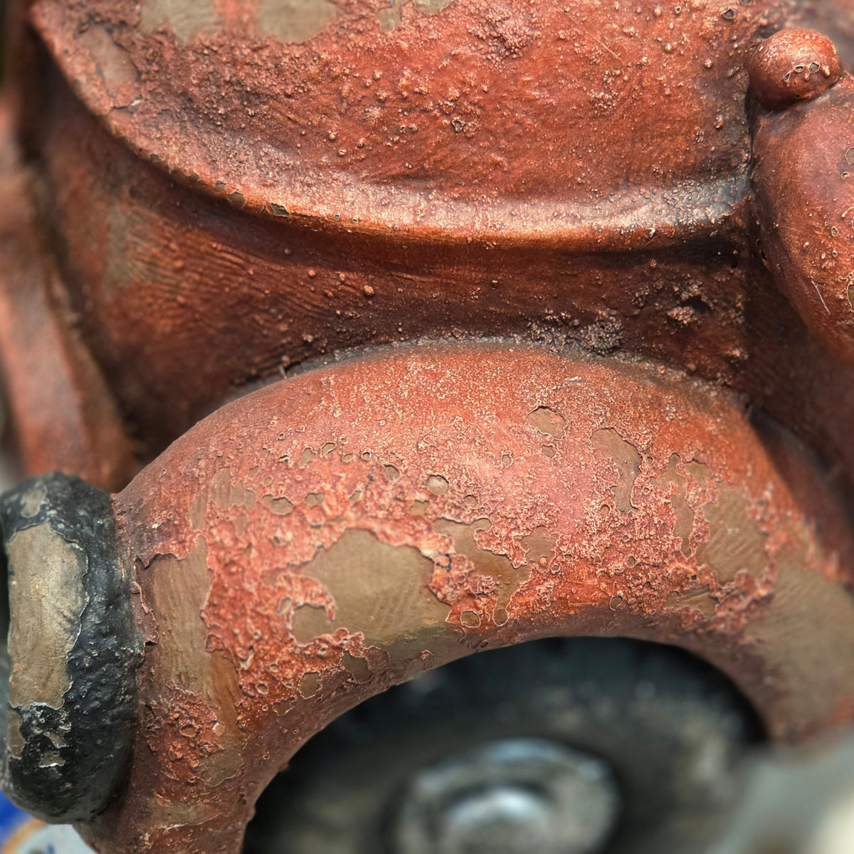 Close-up of the distressed red truck finish and wheel