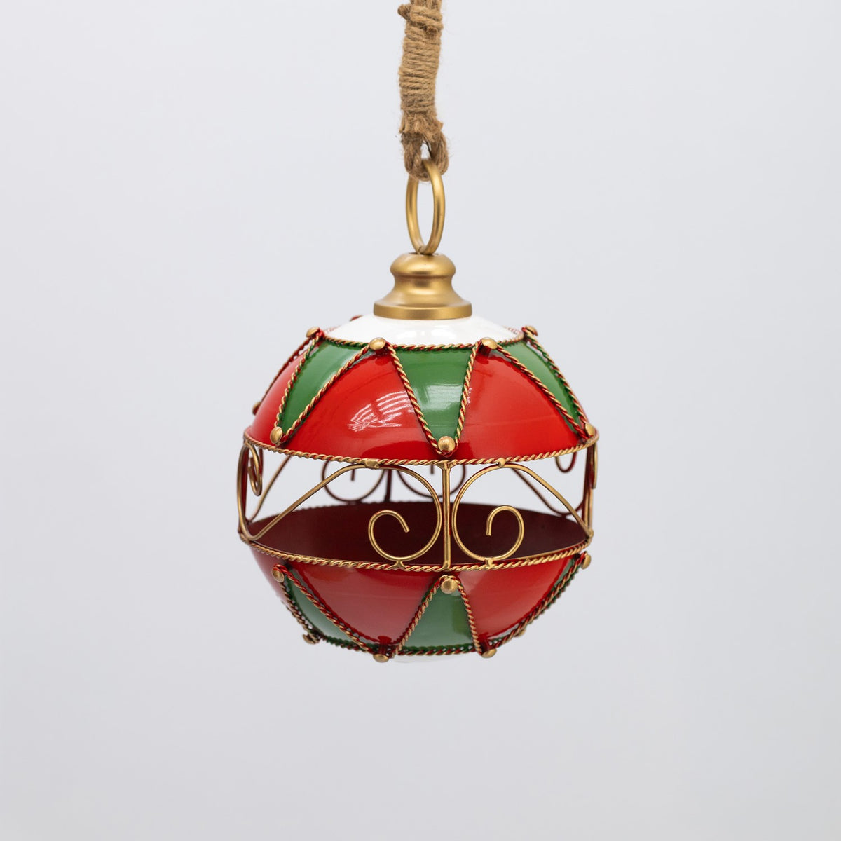 Hanging ornament shown at a distance, with red and green panels and a gold scrollwork center band.