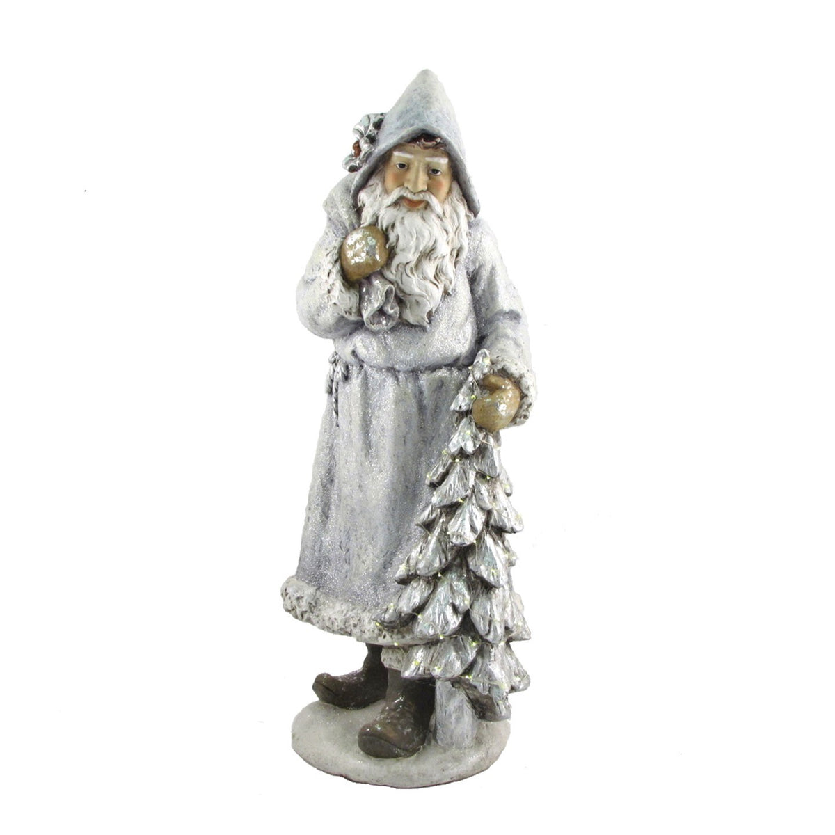 A white-bearded Santa in a gray robe stands with a sack over his shoulder and a snowy Christmas tree.
