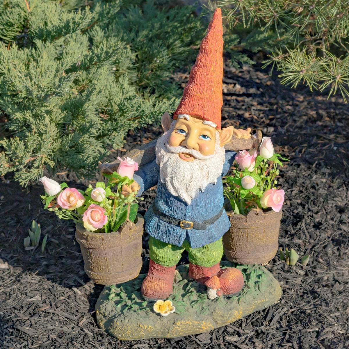 Full view of the gnome holding two flower-filled buckets on a textured garden base.