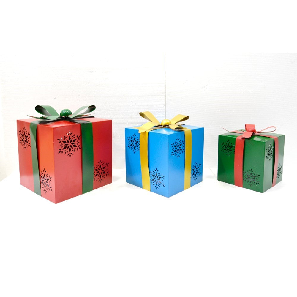 Three colorful metal gift-box garden stakes with ribbon bows and snowflake cutouts, arranged against a white background.