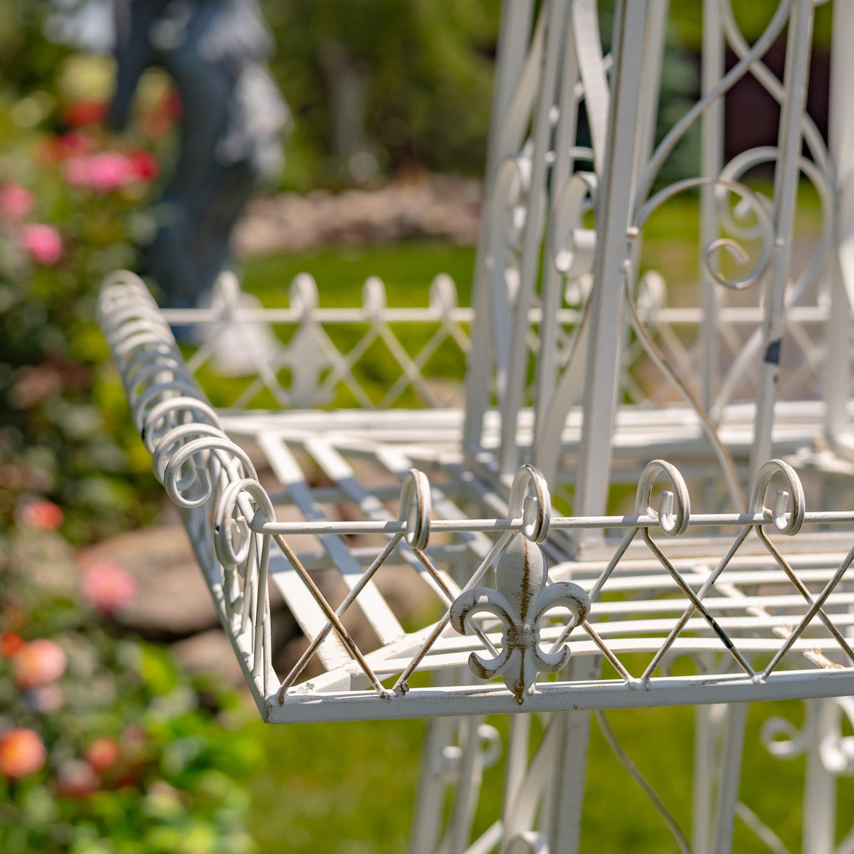 Angled view of the tier corner with looped rail details and a central fleur-de-lis accent.