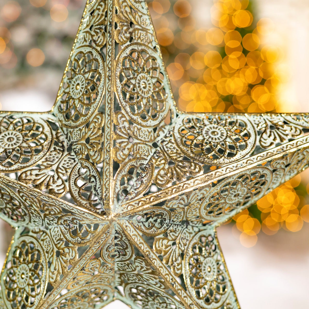 Close-up of the star’s raised metal panels with intricate floral and scrollwork patterns.