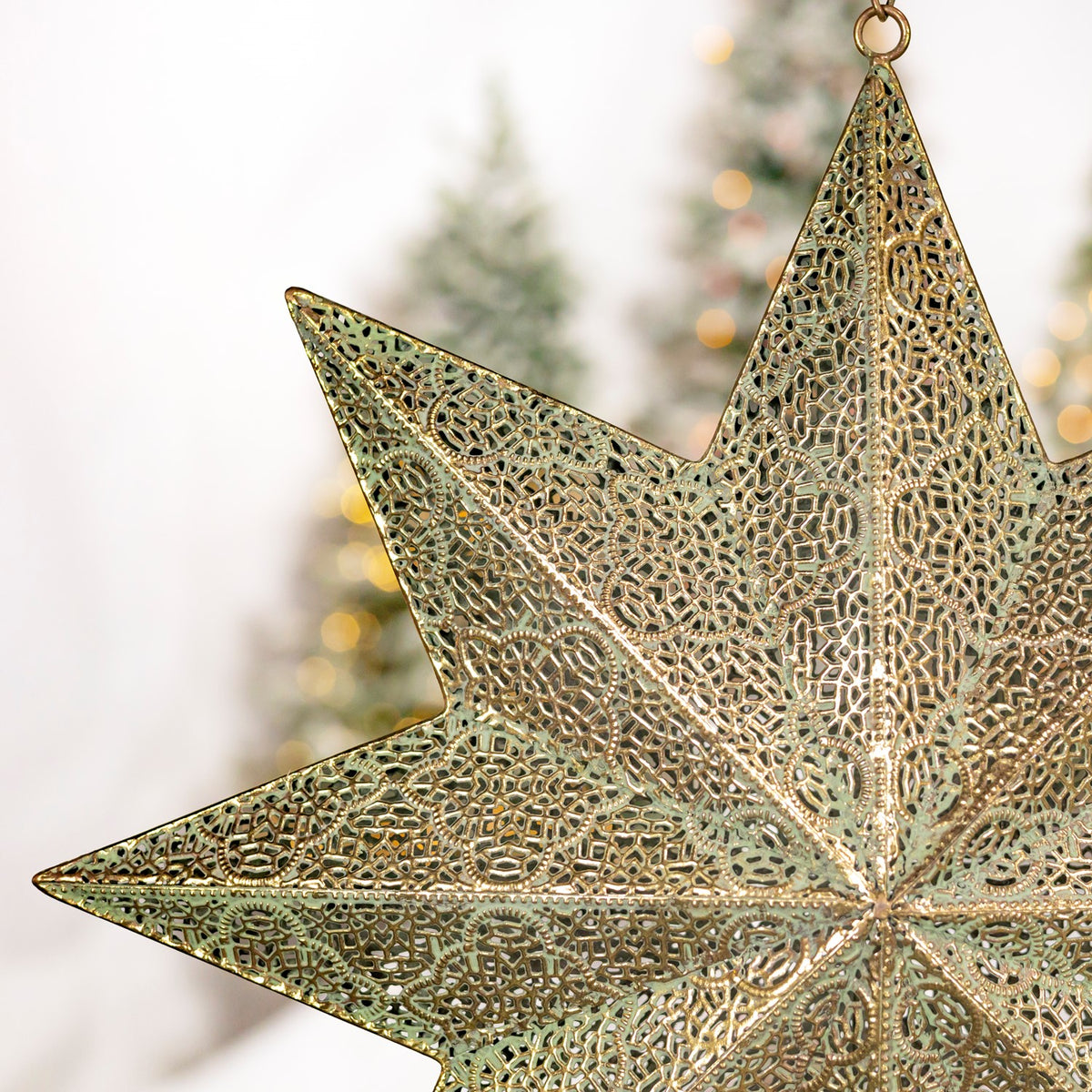 Close-up of the star’s intricate pierced metal pattern and hanging ring.