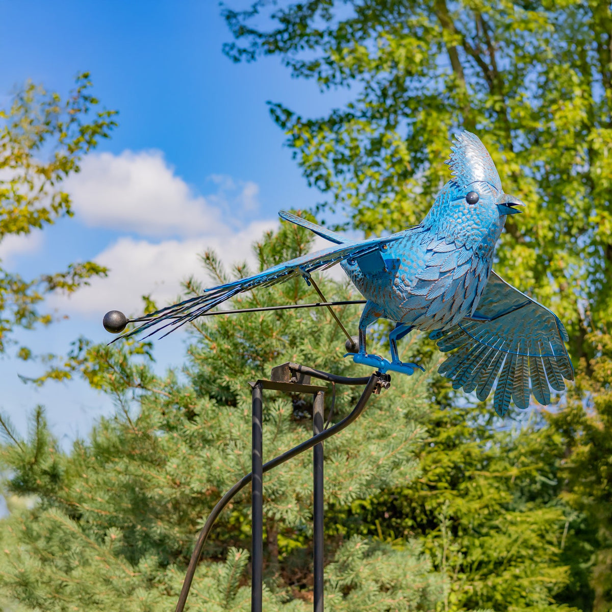 Side view of the blue jay stake, showing its outstretched wings and long iron support with a hanging weight.