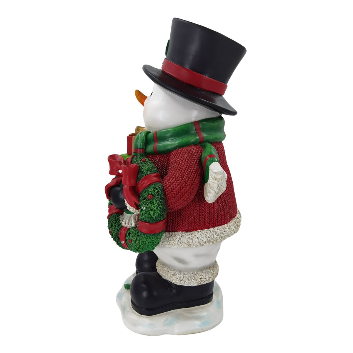 Snowman in profile holding a green wreath decorated with a red bow and ornaments.