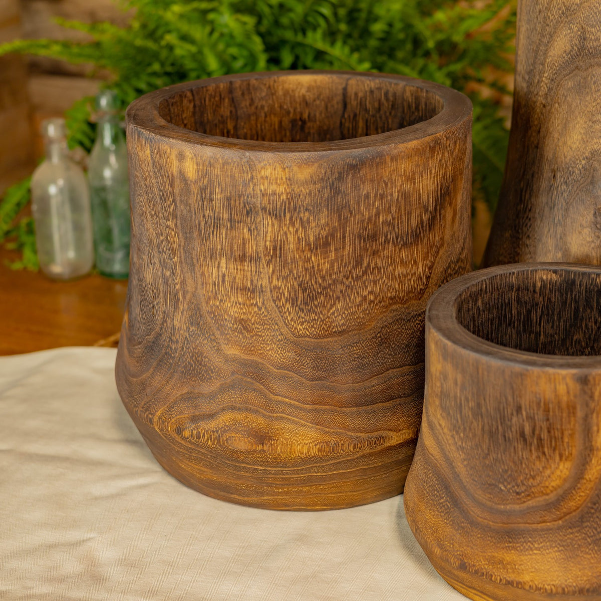 The medium and small wooden bowls shown close together, with their rounded sides and grain visible.