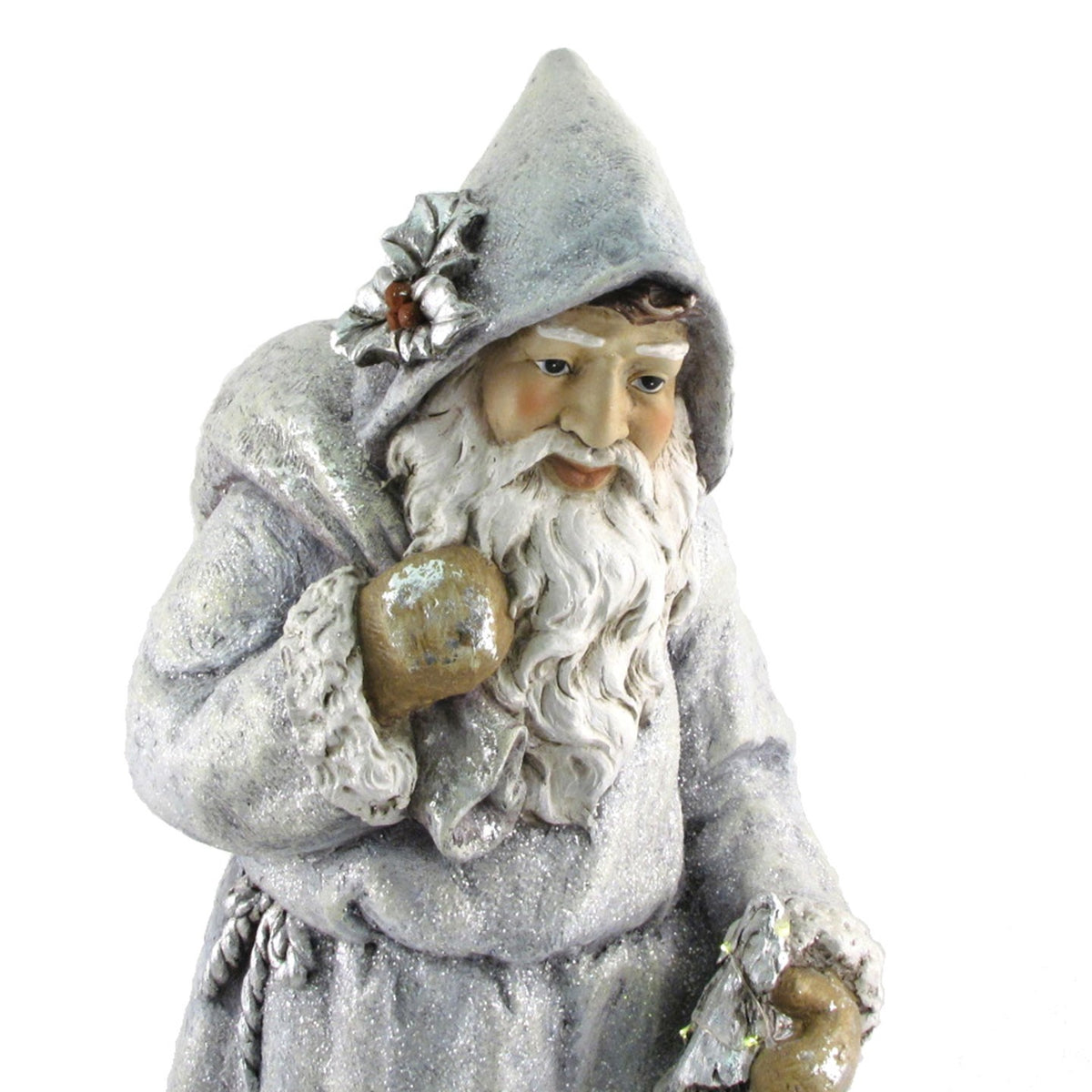 Close-up of Santa’s hooded face, flowing white beard, shoulder sack, and holly decoration.