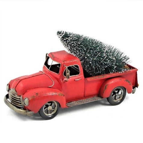 Red pickup with a tree in its bed, viewed from the other front angle against a white background.