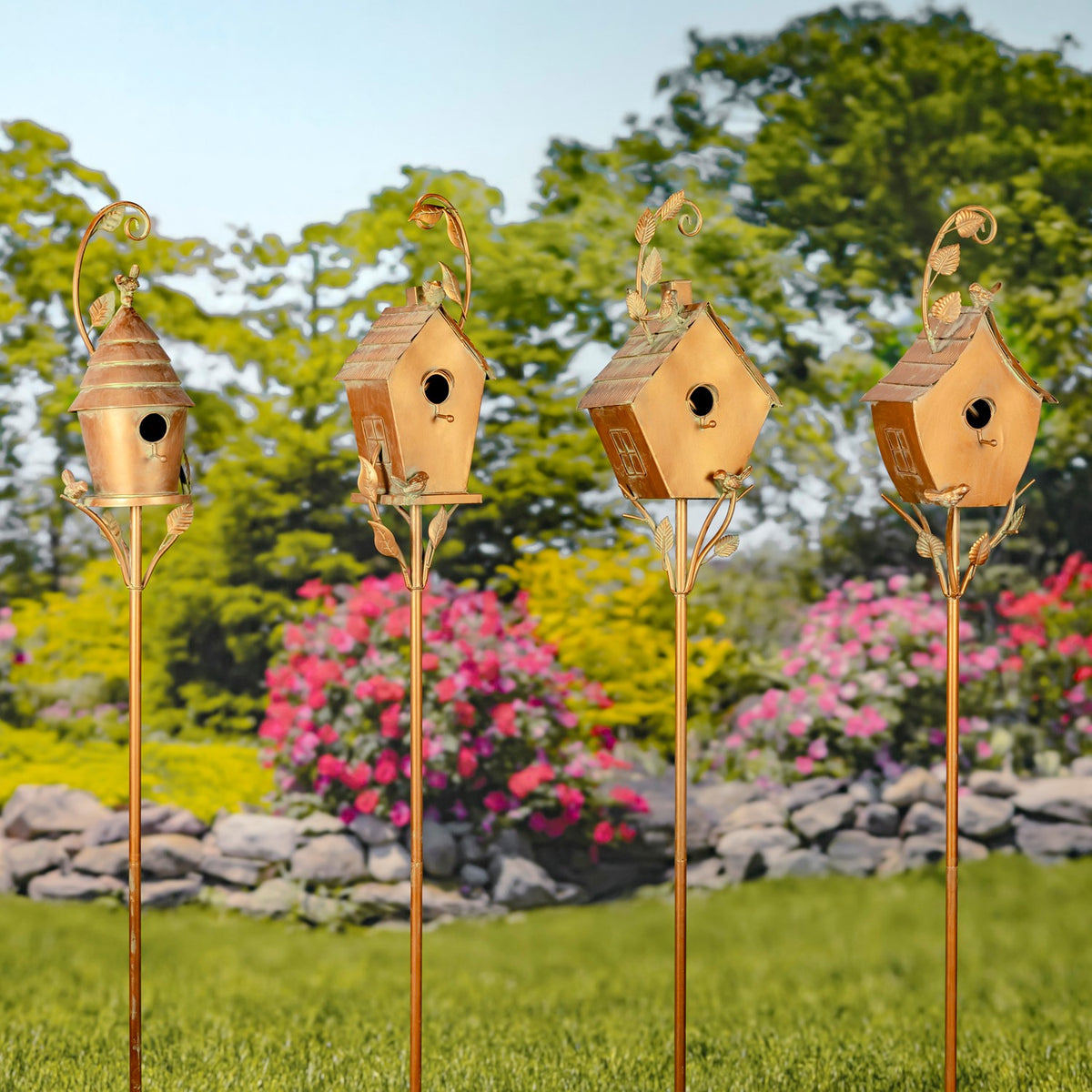 Four copper-toned birdhouse stakes stand in a row, with one round-roofed design and three peaked designs.