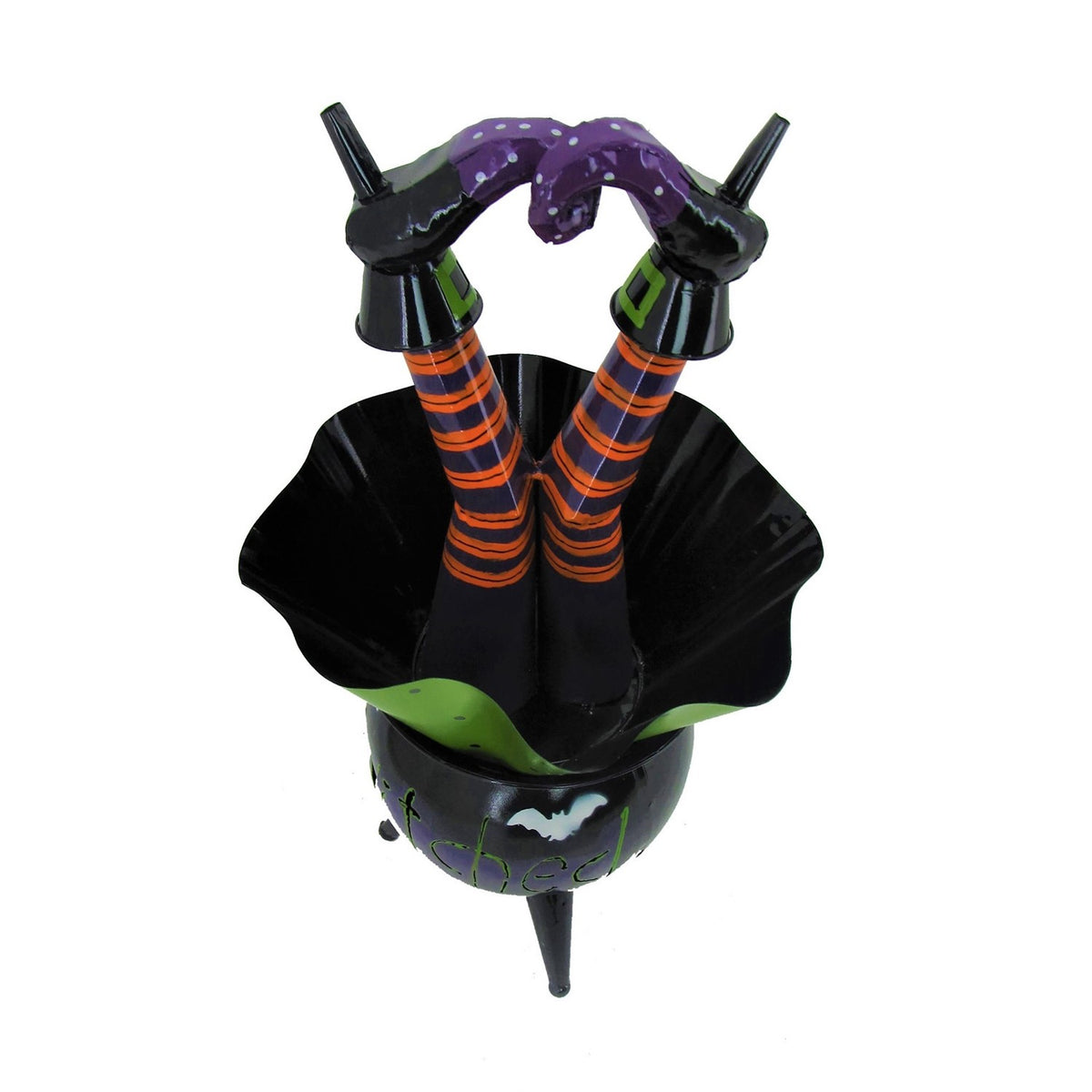 View into the cauldron’s flared black and green opening, with two striped legs and curled shoes above it.