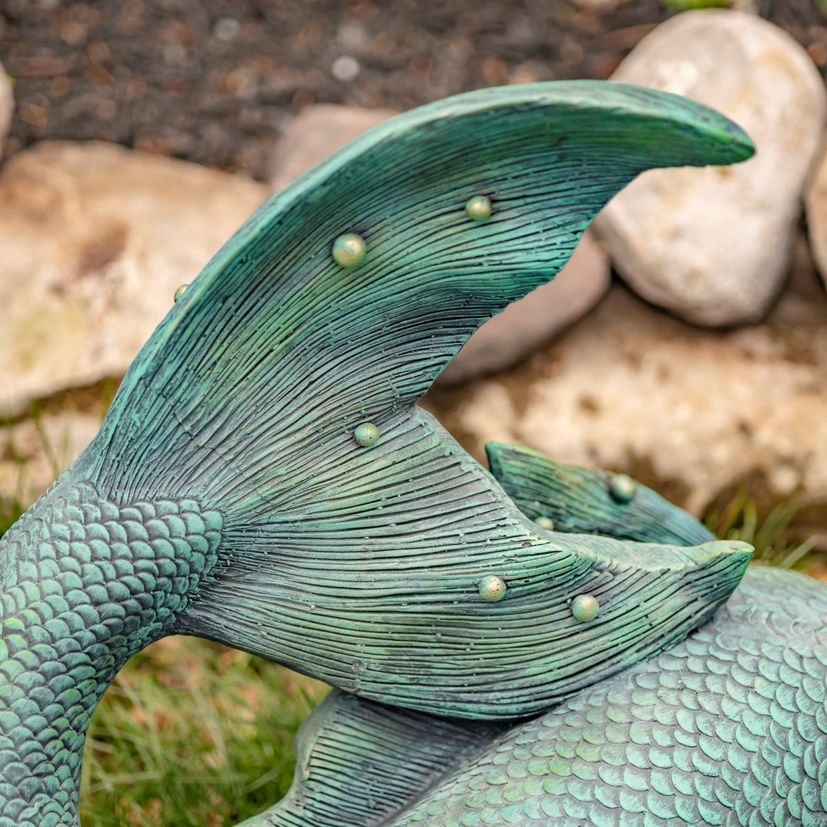Close-up of the curled tail showing raised scales, fine ridges and rounded accents.