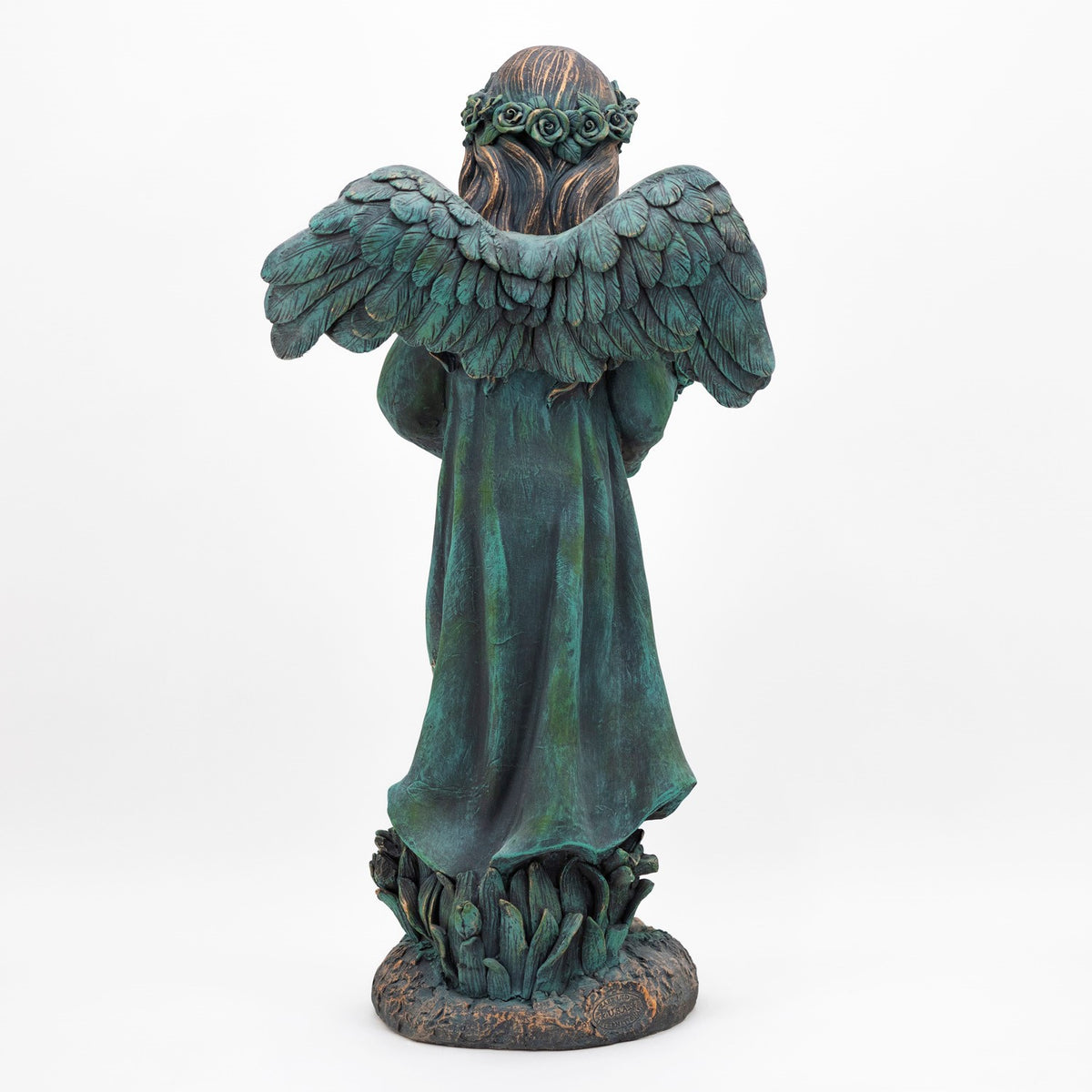 Rear view of the statue showing its outstretched feathered wings and long robe.