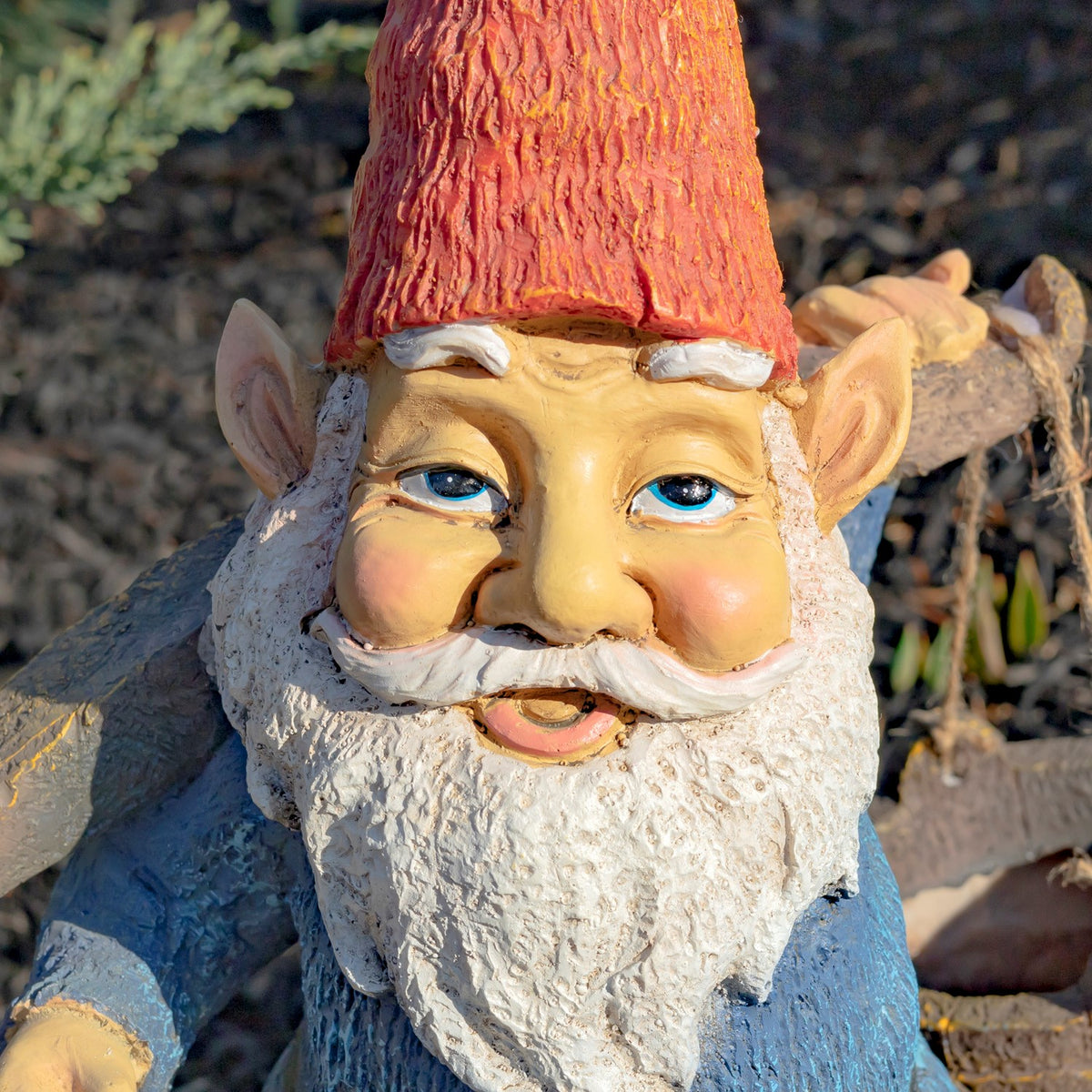 Close-up of the gnome’s face, showing blue eyes, rosy cheeks, curled white mustache and textured beard.