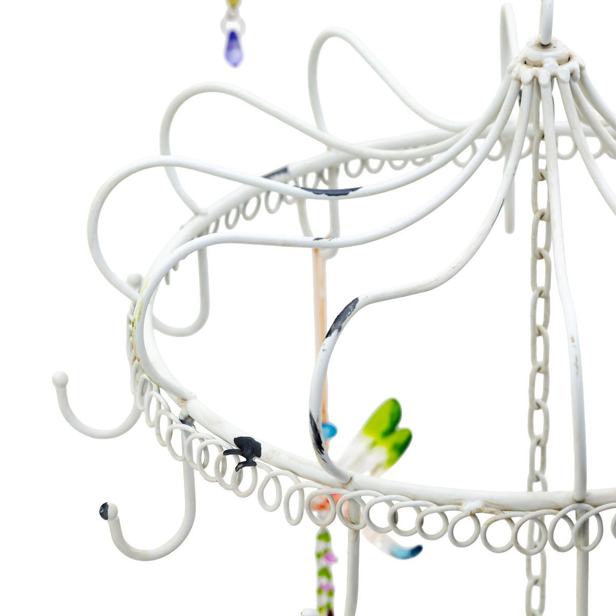 Close-up of curved white metal arms, chain and small looped hooks on the display.