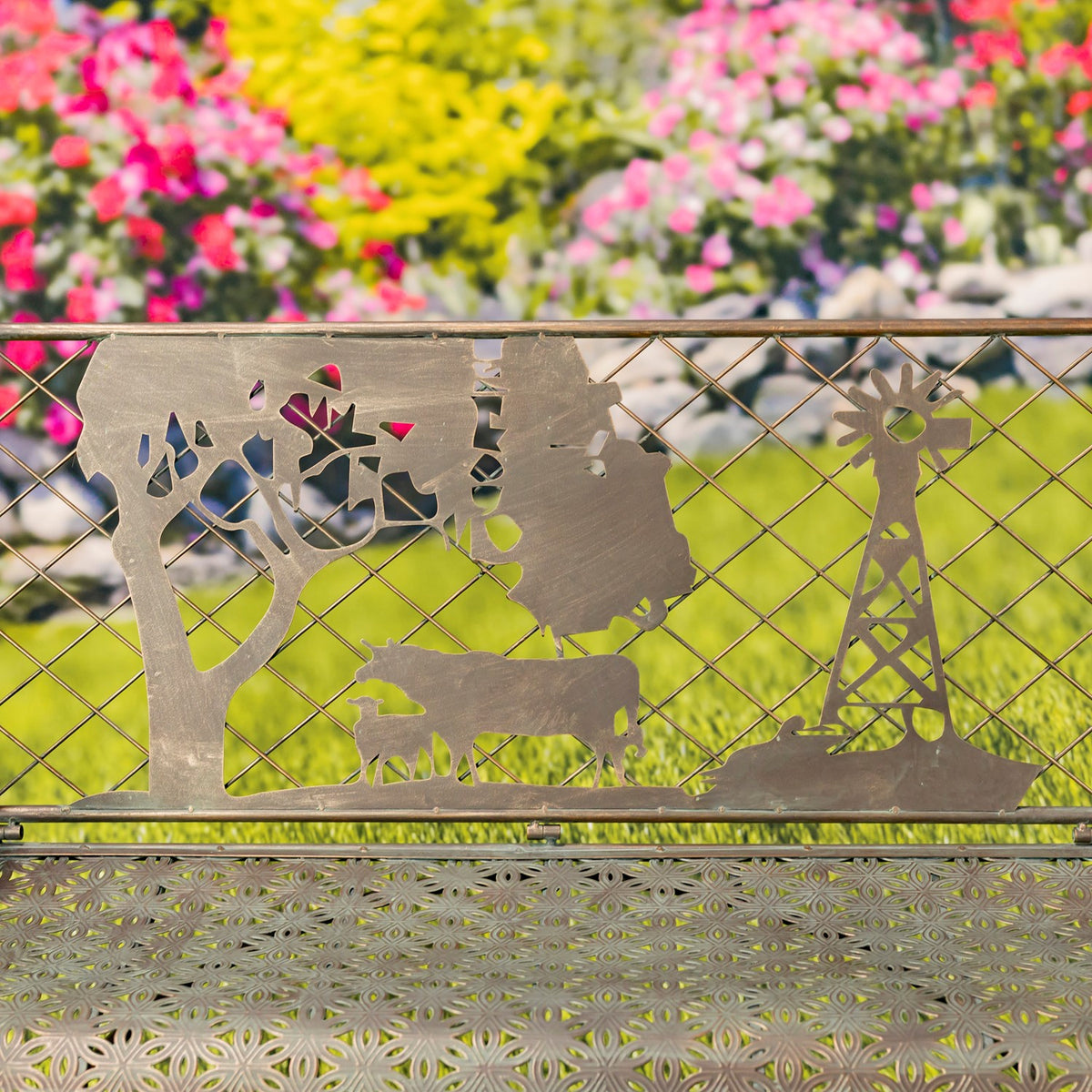 Metal backrest with cutout farm scene showing a cow, tree, and windmill above the patterned seat.