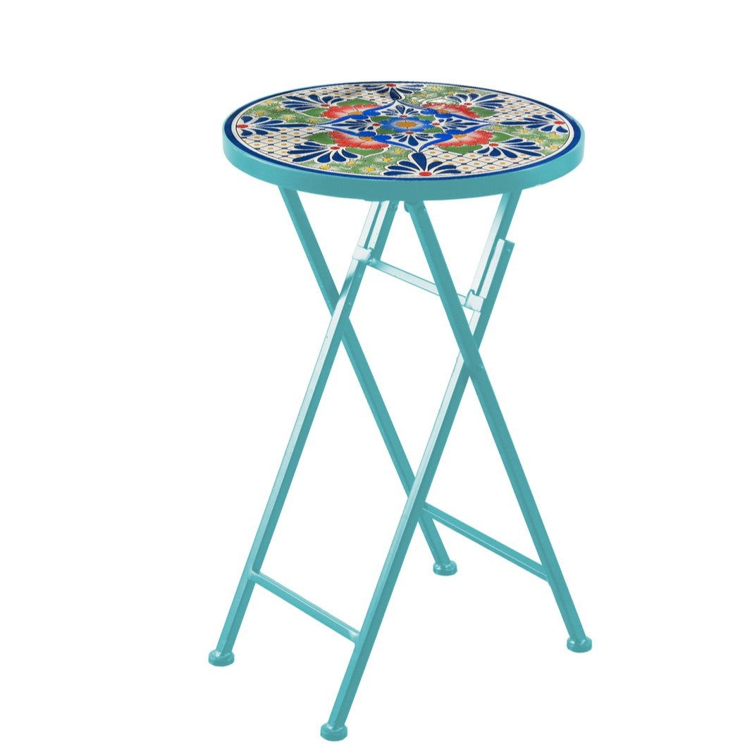 Turquoise folding plant stand with a round, colorful mosaic tabletop against a white background.