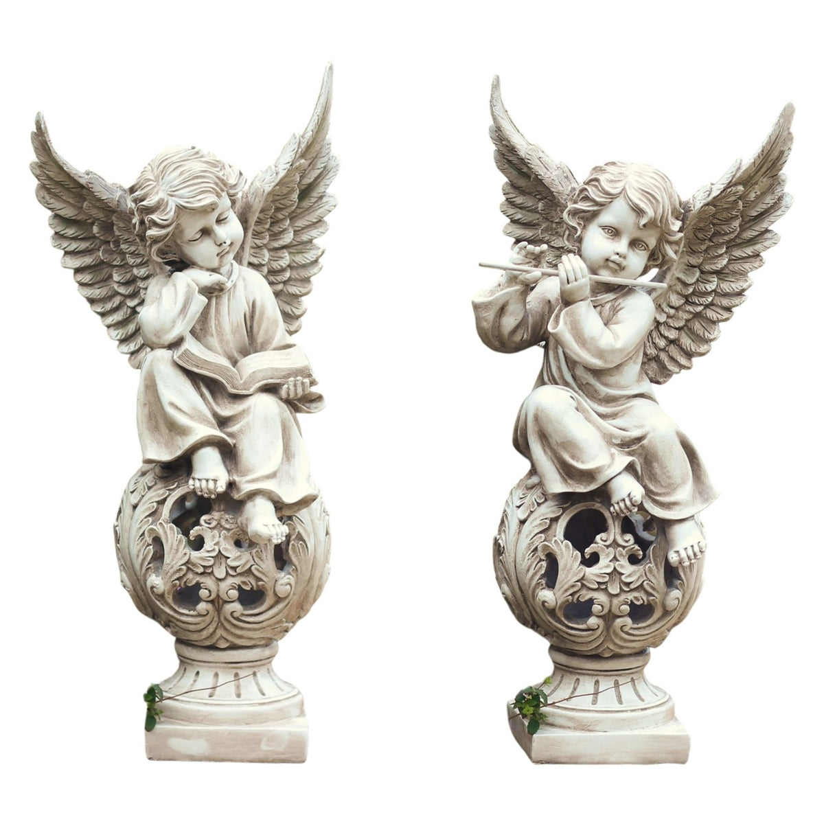 Pair of seated cherubs with outstretched wings, shown on carved spherical bases with square feet.