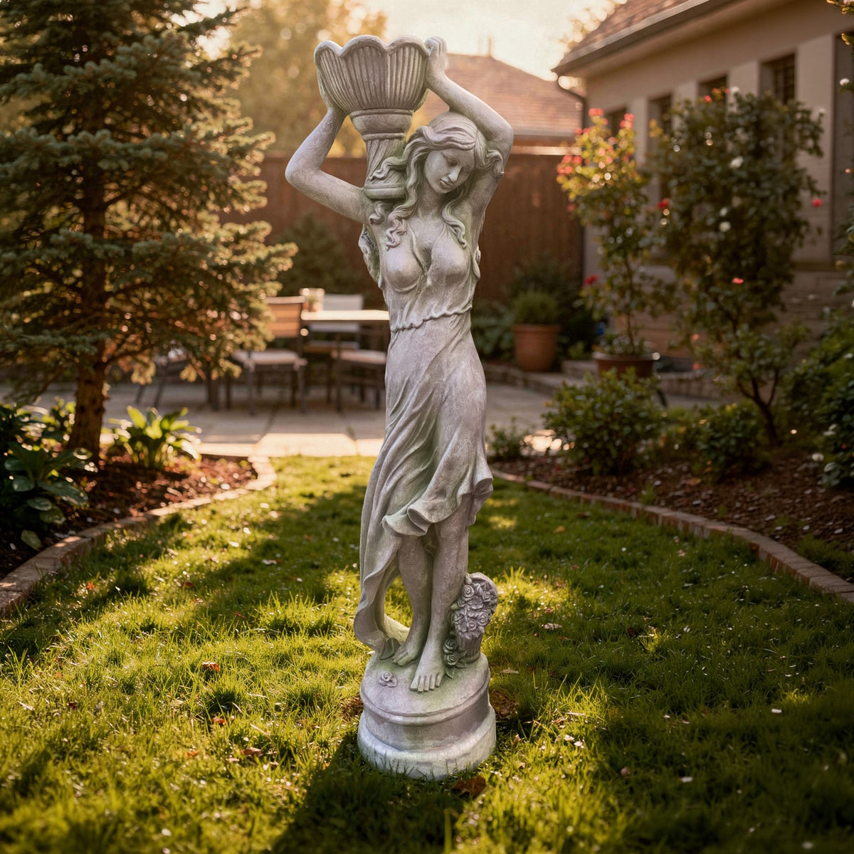 Full-length view of the woman statue carrying a flower pot overhead on a lawn in a garden courtyard.