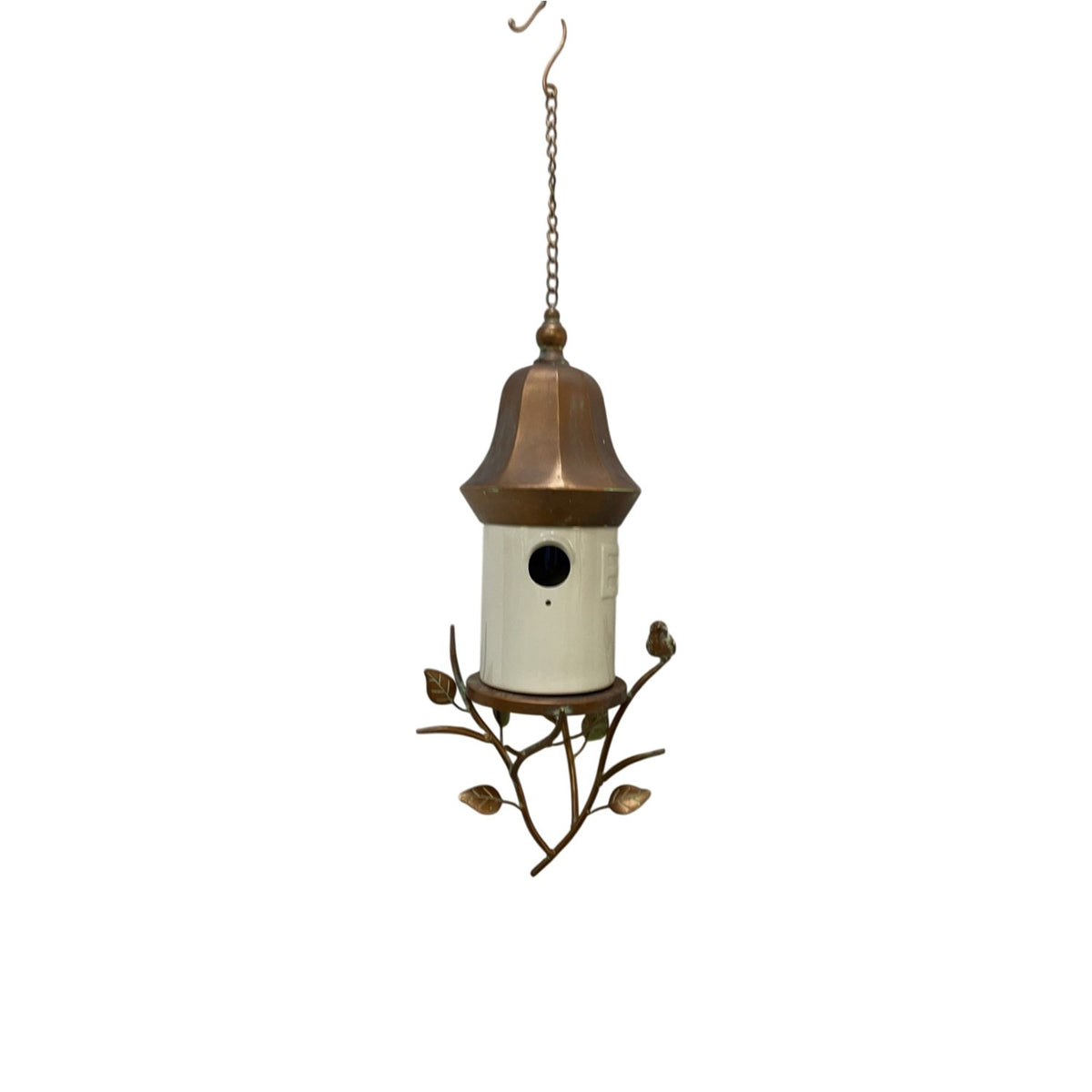 Hanging birdhouse with a white cylindrical body, bronze-tone roof, chain, branch base, and round entrance hole.
