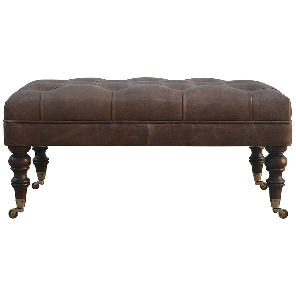 Brown leather ottoman in centered front view with tufted top and turned legs.