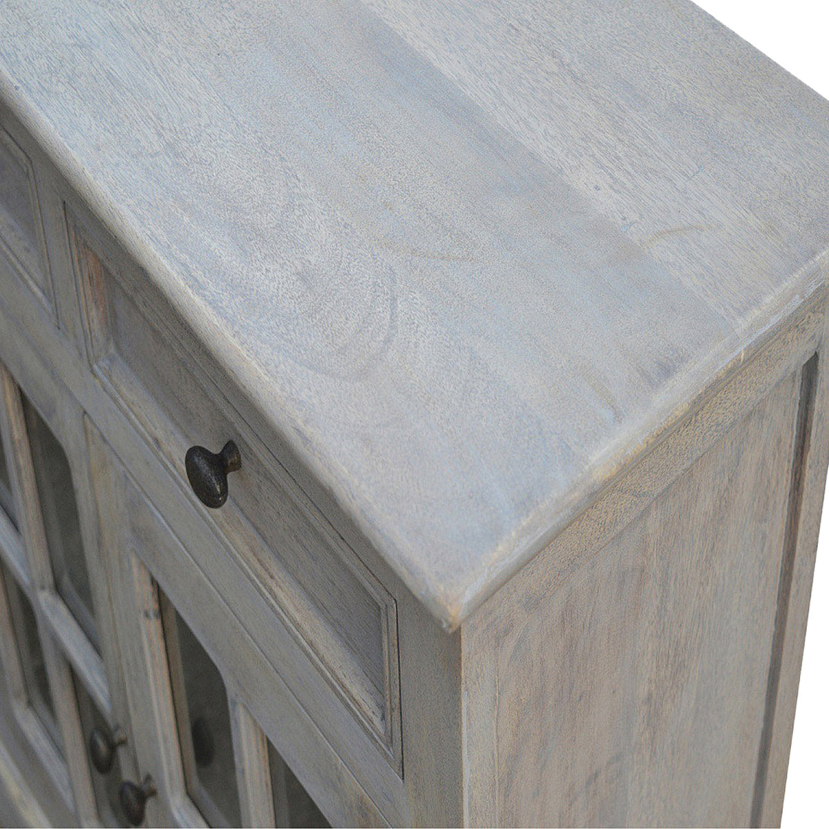 Close-up of the sideboard top corner, pale finish and solid-looking side panel