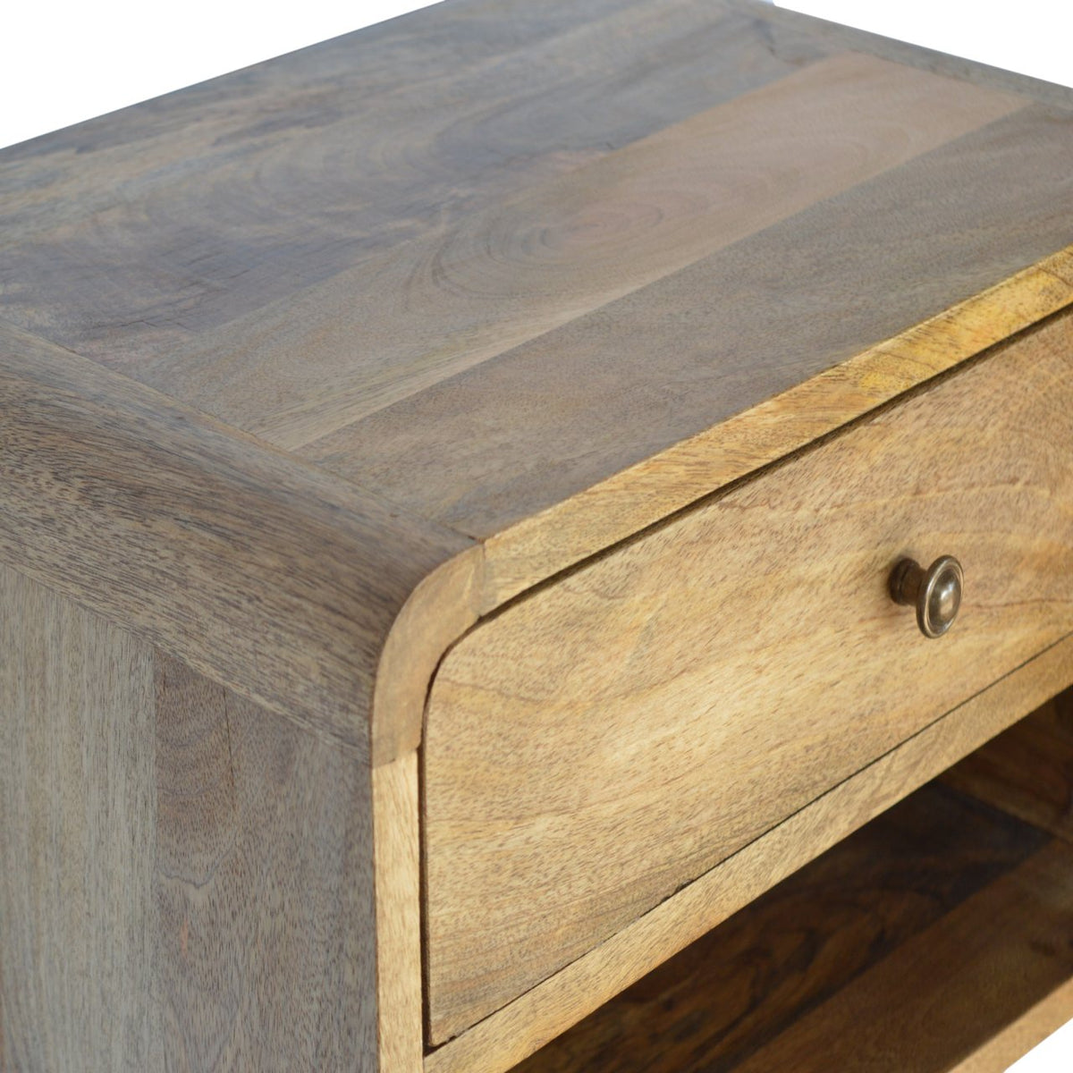 Close-up of the nightstand's wood top, curved edge, and drawer front
