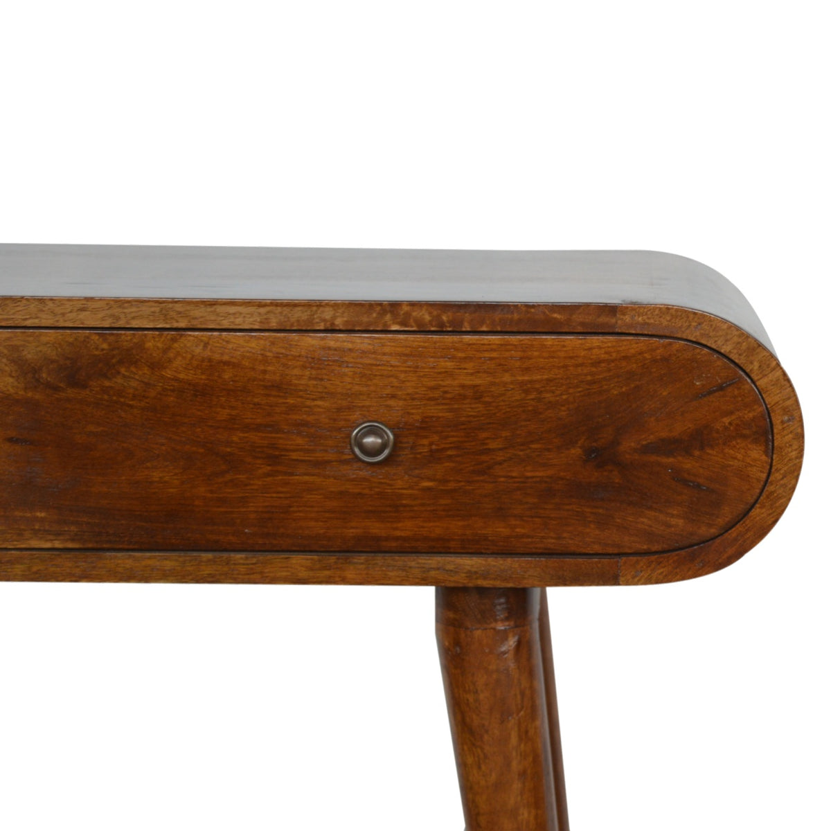 Close-up of a drawer knob, rounded front edge, and table leg