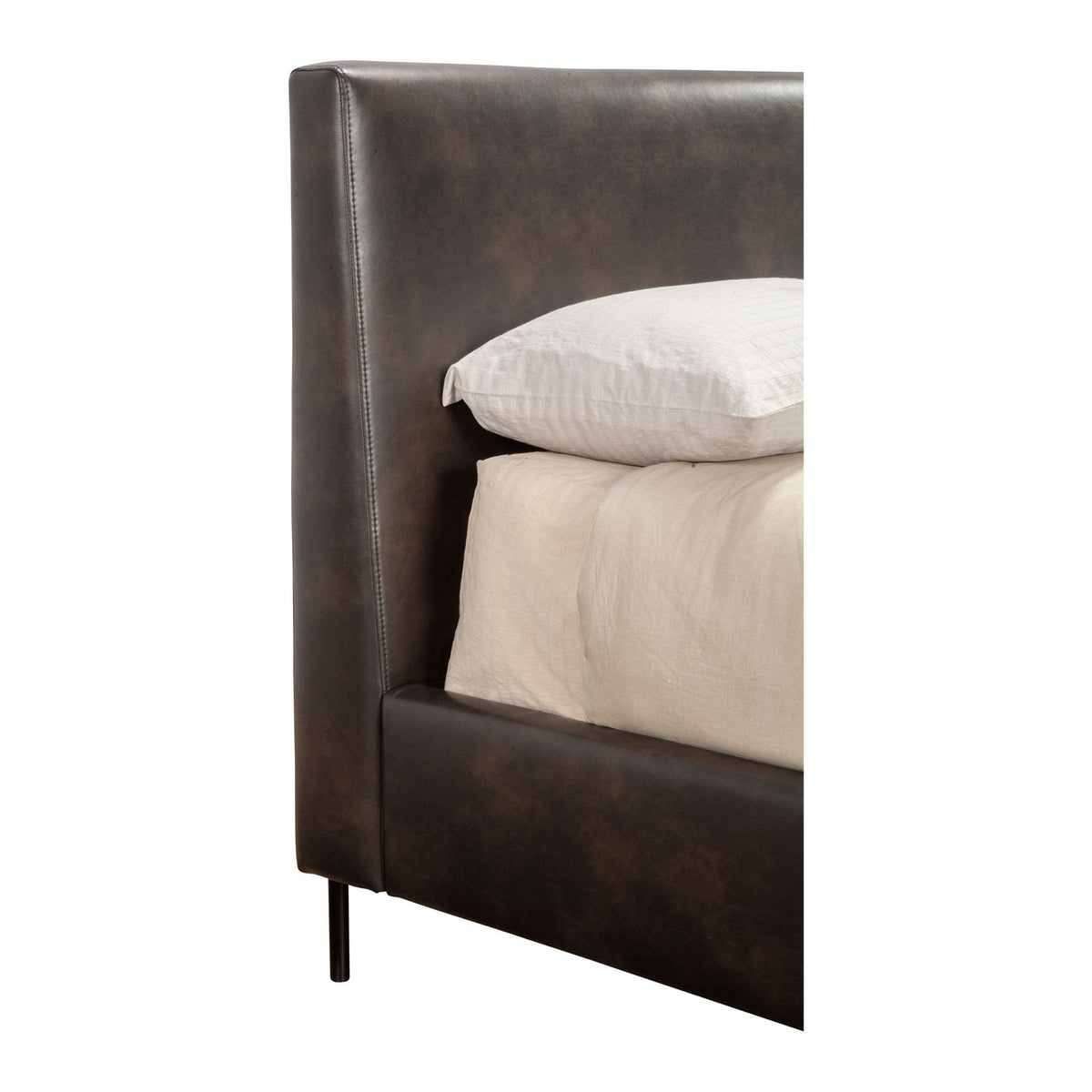 Close-up of the dark faux leather headboard, side rail, and metal leg