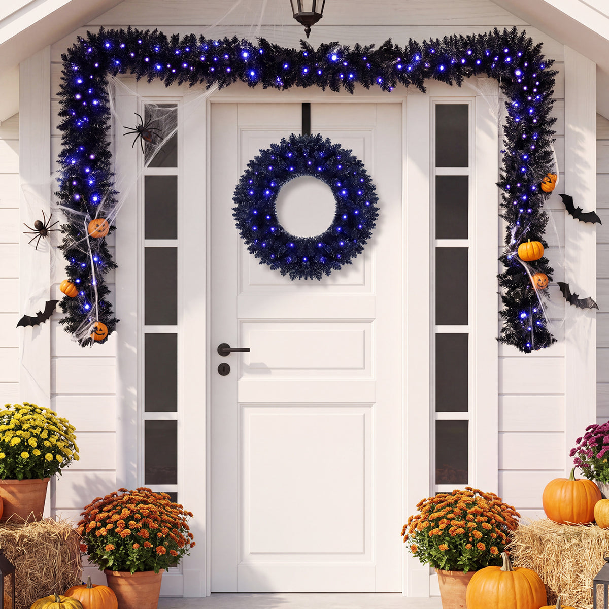 Blue-lit wreath and garland frame a white doorway decorated with pumpkins, spiders and autumn flowers.